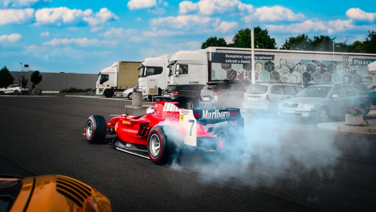 Murcielago with flames chasing an F1 car on highway (2025)