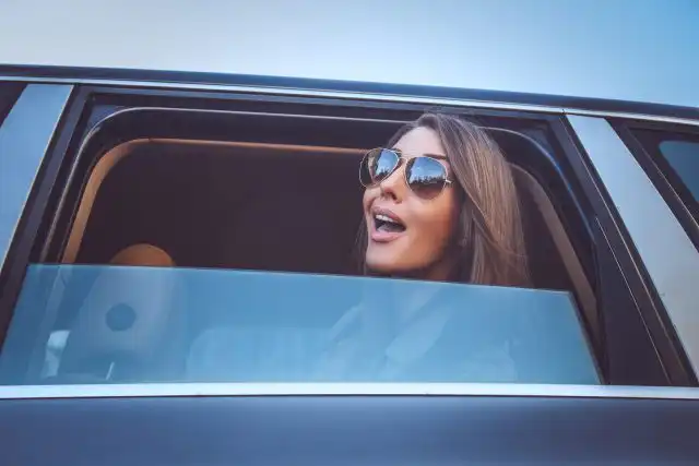 A woman in sunglasses looking outside